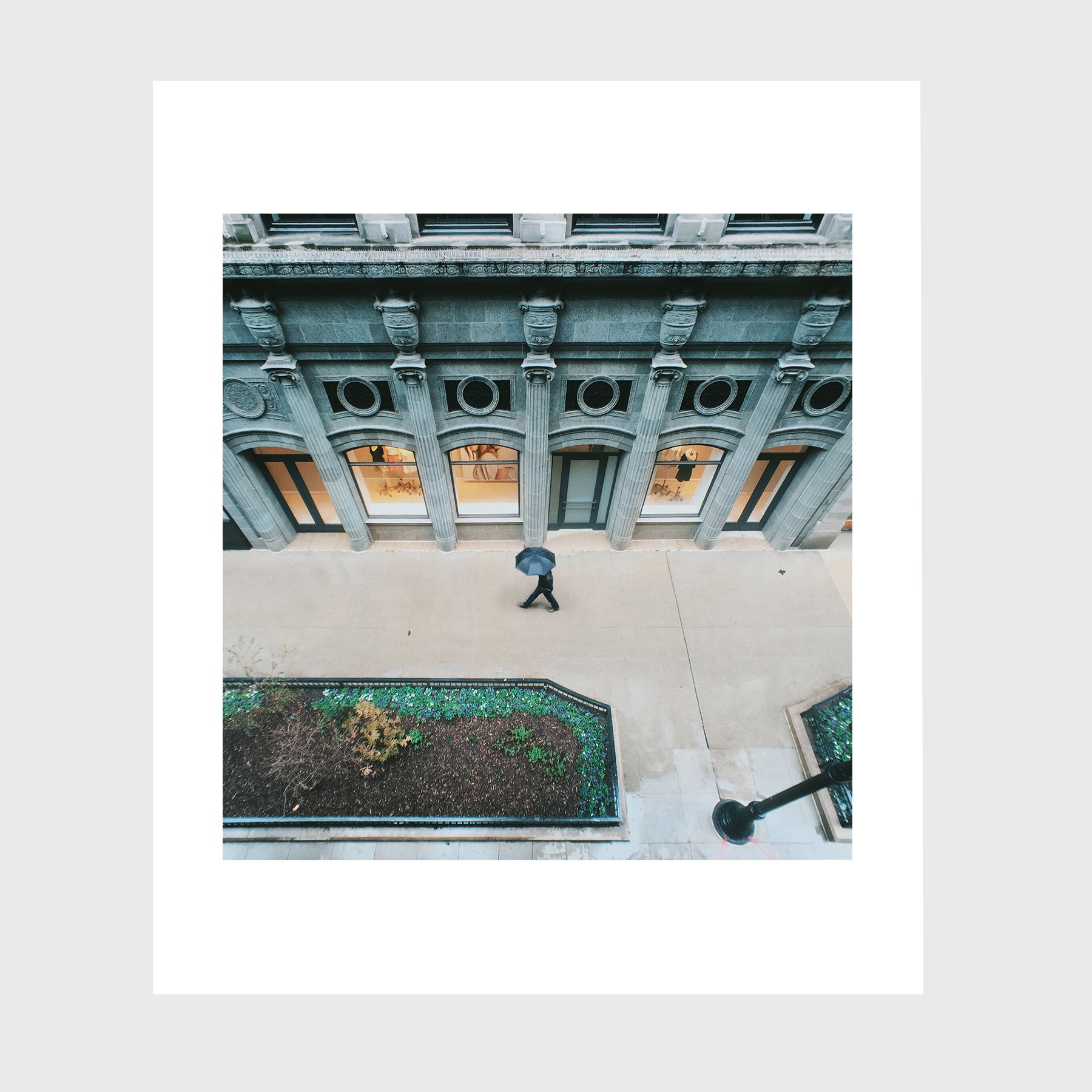 Man with Umbrella on Sidewalk